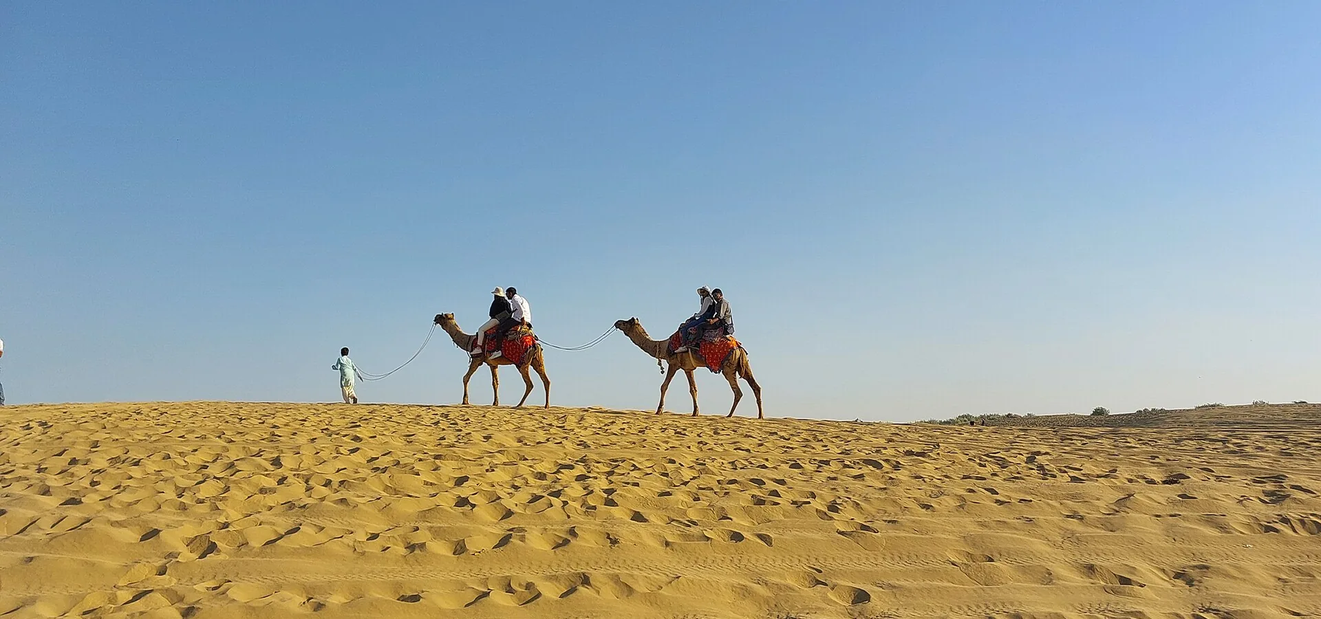 Camel riders on the dunes near Jaisalmer